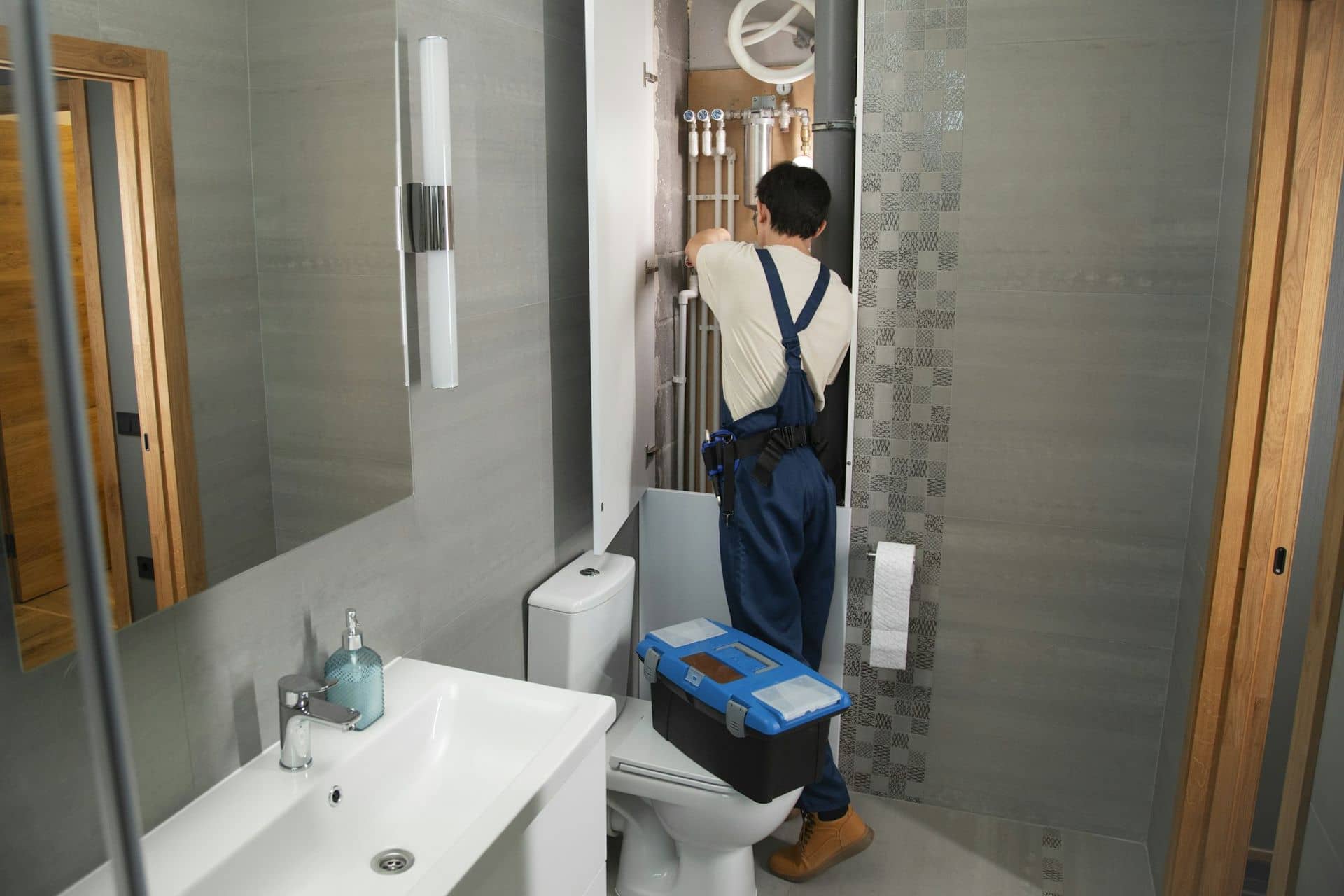 A plumber at work in a customer's home