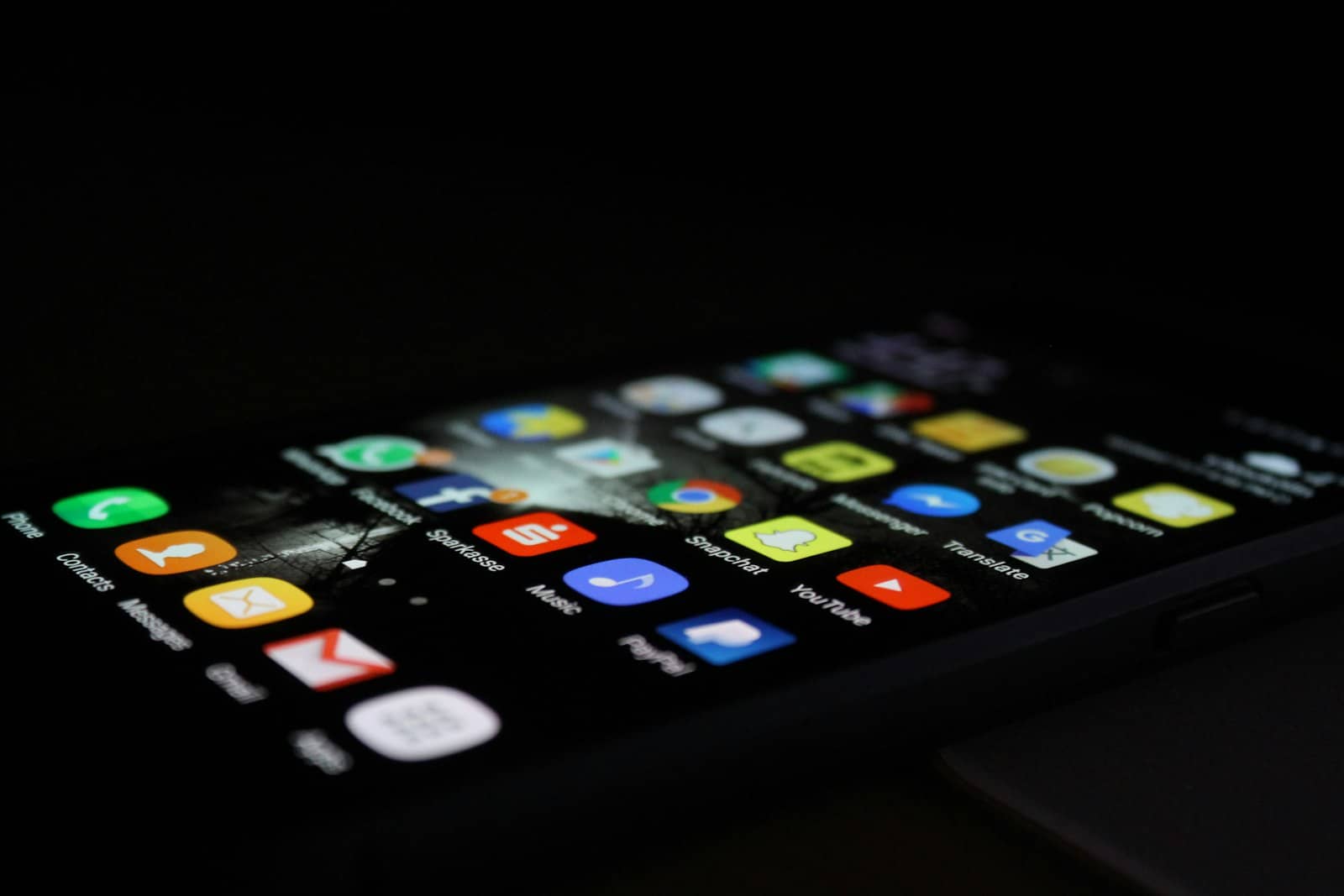 A laptop and a phone showing customer messages side by side
