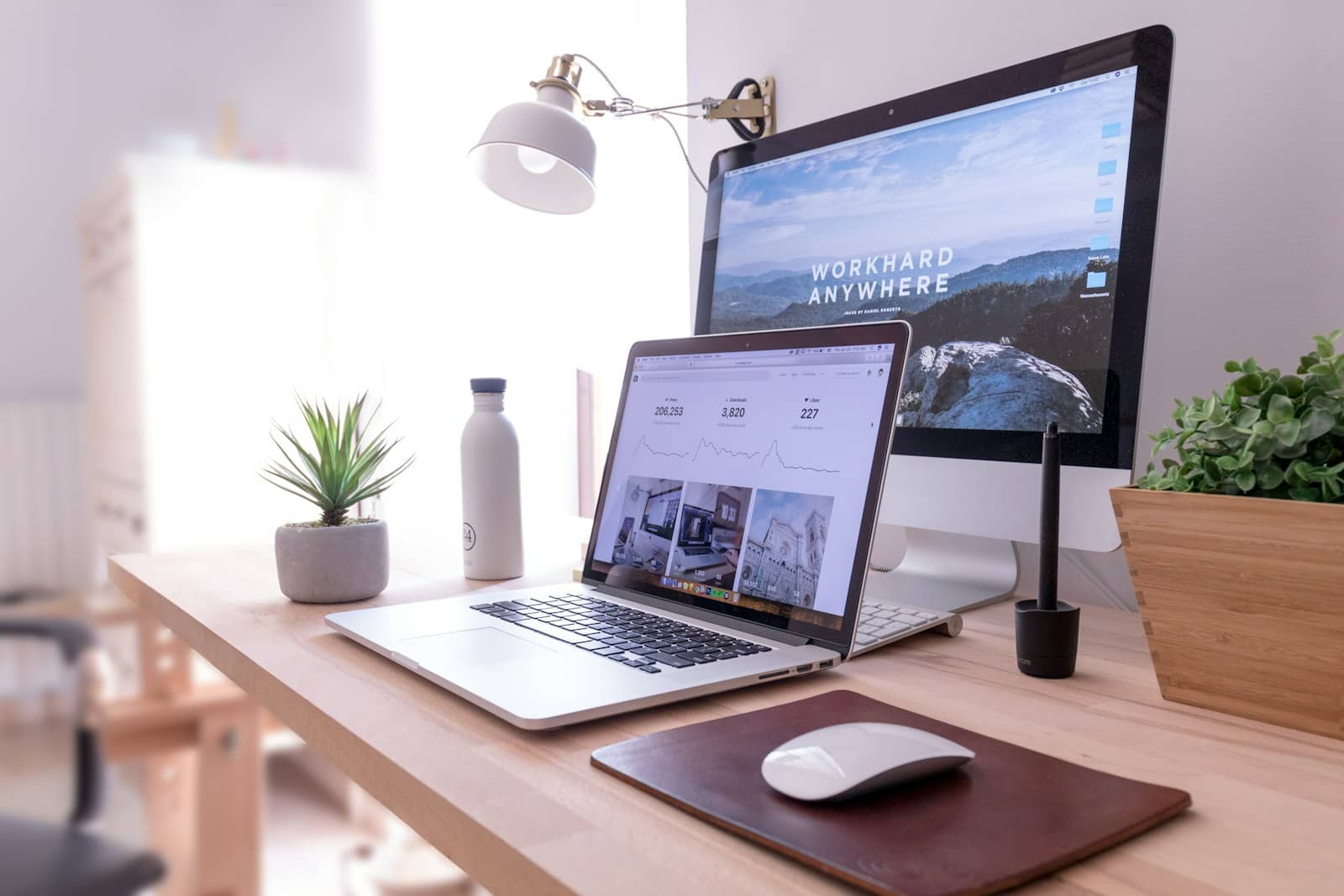 Modern workspace with monitors showing a website build