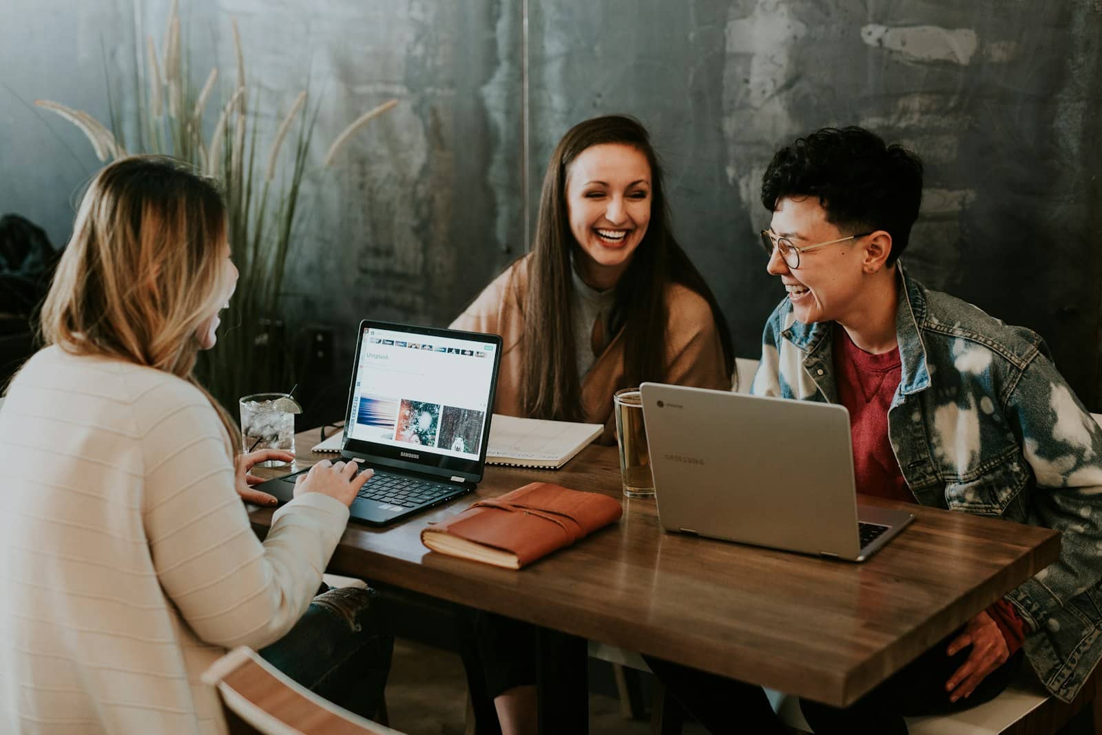 A small team collaborating around laptops in a bright office