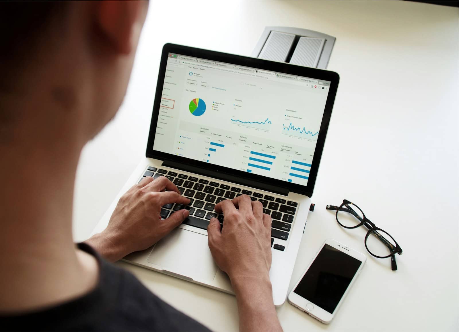 A person reviewing marketing performance on a laptop