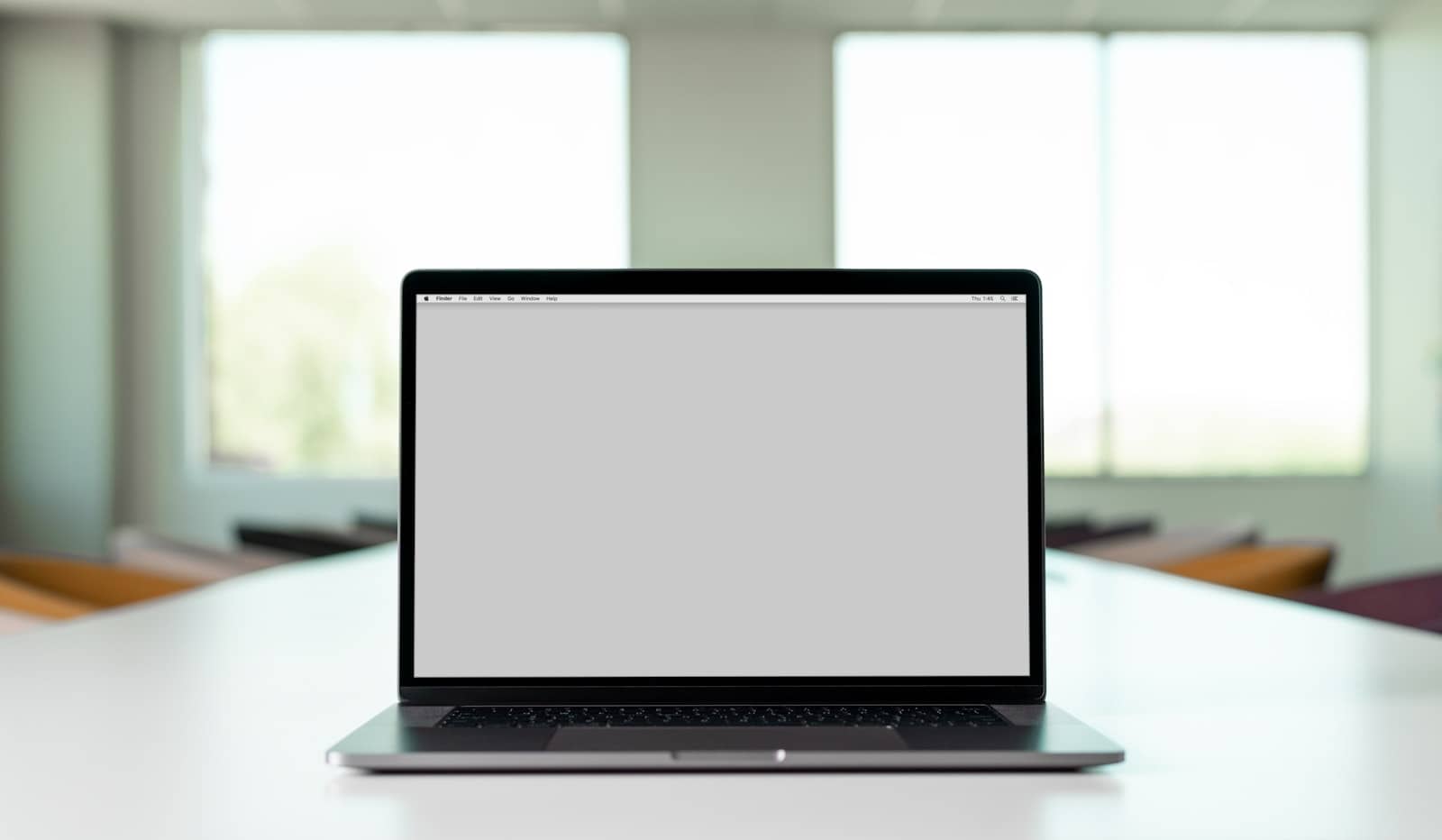 A person working at a laptop, reachable for support