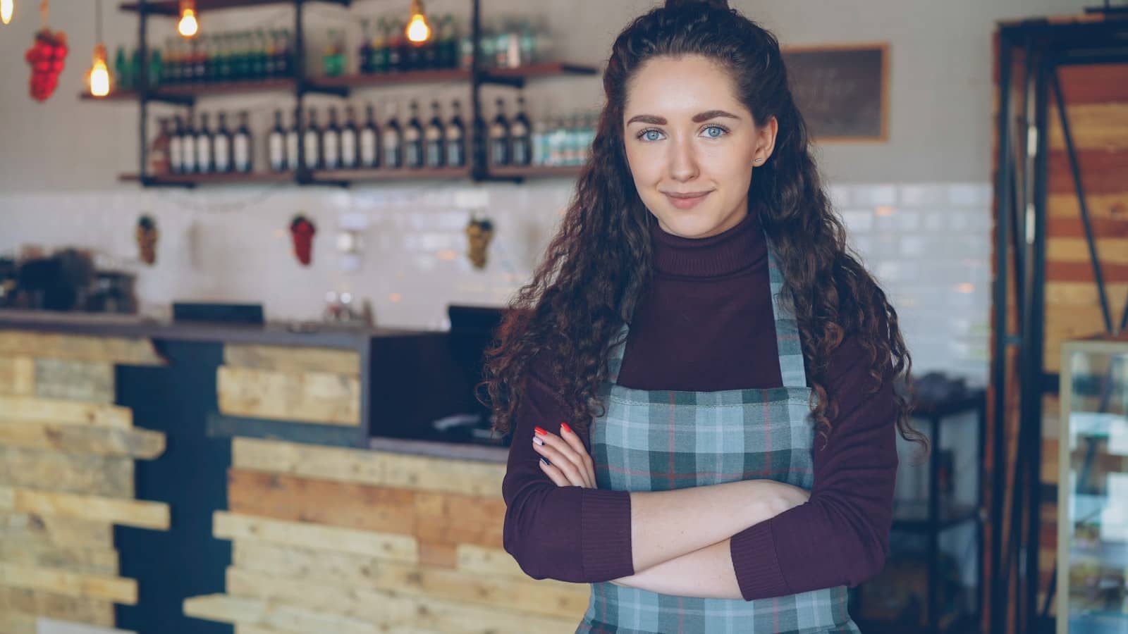 A small business owner at the counter of their shop