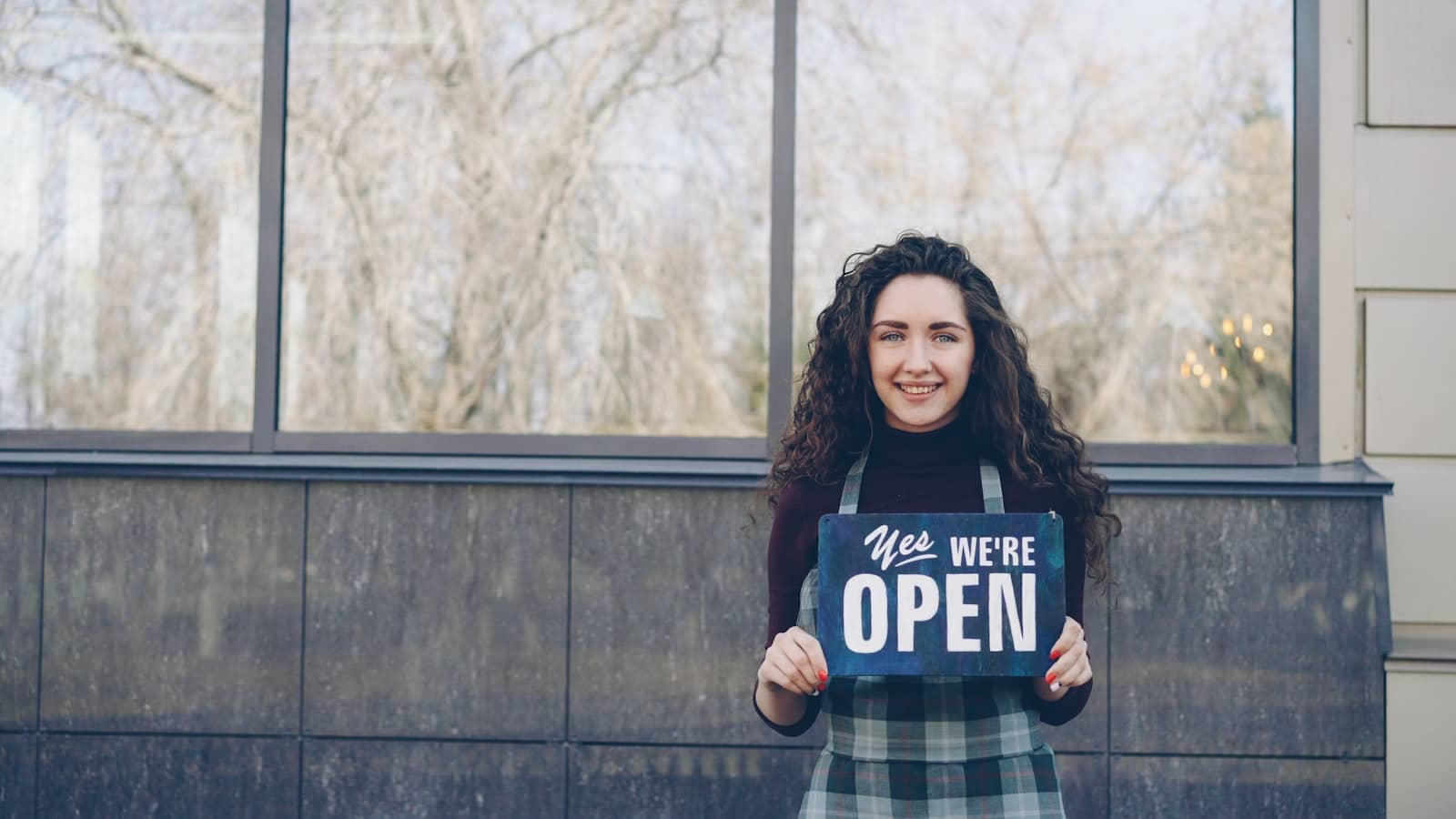 Small business owner standing in their shop, confident their business shows up correctly online
